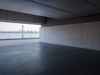 an empty space with windows that have large panes overlooking the city of london on the water