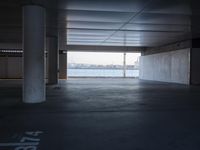 an empty space with windows that have large panes overlooking the city of london on the water
