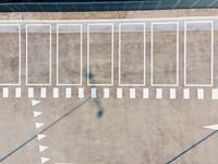 an aerial view of the inside of a parking lot and train tracks and tracks with cars on the street in a city