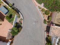 an aerial photo of a residential street in an area with houses, trees, and landscaping