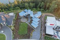 a bird's - eye view of an aerial residential area overlooking the water and trees