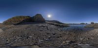 fisheye lens, taken above the beach of a rocky shoreline with rocks and water