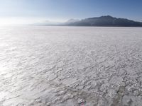 an aerial view of the vast salt flats in the usa with some mountains on the horizon