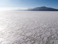 an aerial view of the vast salt flats in the usa with some mountains on the horizon