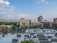 several large empty parking spaces in the city with buildings nearby in front of them -