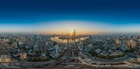 an aerial photo looking over the city towards the water at sunset with skyscrapers on the horizon