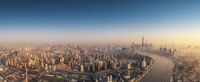 a view of the city from an airplane of a big city with tall buildings and roads in the middle