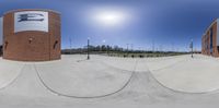 this is a fish - eye photo looking up at a skateboard ramp in front of a building