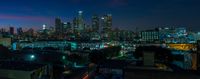 there is a very high rise view of a city from a building in the night