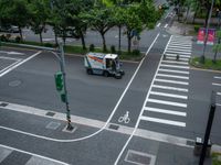 an overhead view of a street with multiple crosswalks and lots of trees surrounding the intersection