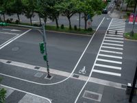 an overhead view of a street with multiple crosswalks and lots of trees surrounding the intersection