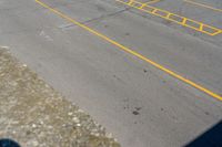 parking meters and parking spaces on the side of a road with parking spaces painted yellow