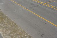 parking meters and parking spaces on the side of a road with parking spaces painted yellow