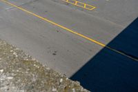 parking meters and parking spaces on the side of a road with parking spaces painted yellow