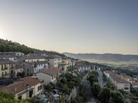 a long country road in front of a town with a view of a valley below