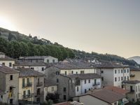 a long country road in front of a town with a view of a valley below