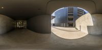 a man is riding his skateboard in a ramp area of a building that has multiple spherical arches