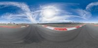 a 360 - angle view of a track with clouds over it and the camera panning it