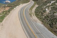 Aerial view of a winding road along a coastal line