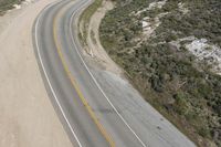 Aerial view of a winding road along a coastal line