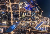 the view from an aerial point of the city at night, including streets, skyscrapers and buildings