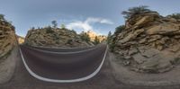 a long winding mountain road in the middle of nowhere in america, shot using 360 - angle lens