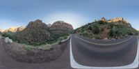 the mountain is shown with three fisheyes on top of it and an empty road below them