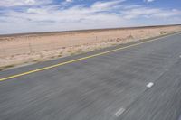 Africa: Rolling Plains under Clear Sky on an Asphalt Road