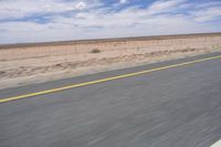 Africa: Rolling Plains under Clear Sky on an Asphalt Road