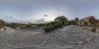 an 360 - fisheye image of a residential building with stairs and a tree on the front