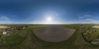 there is a beautiful sky view on this farm fields and the view from a fish eye lens