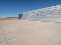 an airplane sitting in an airport next to the runway with no clouds or rain on it