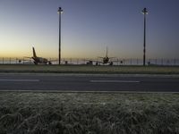 Airplane on Asphalt Runway at Dawn