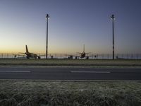 Airplane on Asphalt Runway at Dawn