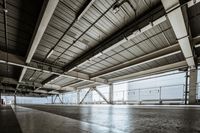 a plane is parked in an airplane hanger at an airport, with another plane nearby