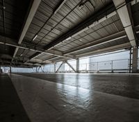 a plane is parked in an airplane hanger at an airport, with another plane nearby