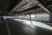 a plane is parked in an airplane hanger at an airport, with another plane nearby