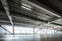 a plane is parked in an airplane hanger at an airport, with another plane nearby