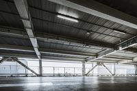 a plane is parked in an airplane hanger at an airport, with another plane nearby