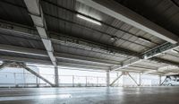 a plane is parked in an airplane hanger at an airport, with another plane nearby