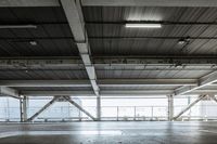 a plane is parked in an airplane hanger at an airport, with another plane nearby