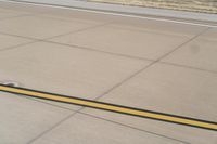 the airplane is getting ready for take off on the runway at an airport with brown grass and blue sky