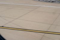 the airplane is getting ready for take off on the runway at an airport with brown grass and blue sky