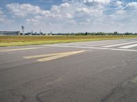 an airplane taxiing down the street from an airport runway with a view in the distance