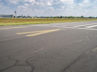 an airplane taxiing down the street from an airport runway with a view in the distance