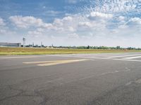 an airplane taxiing down the street from an airport runway with a view in the distance