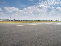 an airplane taxiing down the street from an airport runway with a view in the distance