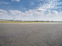 an airplane taxiing down the street from an airport runway with a view in the distance