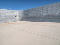 a man skateboarding inside the middle of an outdoor space filled with concrete blocks and concrete walls