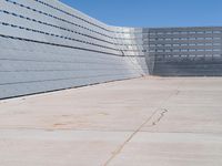 a man skateboarding inside the middle of an outdoor space filled with concrete blocks and concrete walls